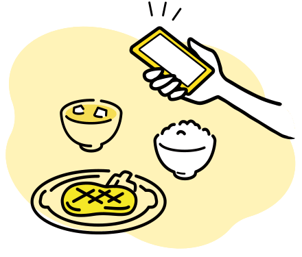 スマホで食事を撮影している画像